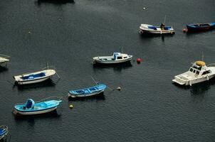 boats in the harbor of santorini photo