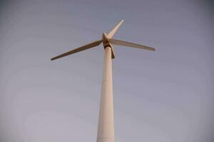 a wind turbine is shown against a gray sky photo