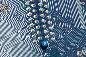 close up of a circuit board with blue buttons photo