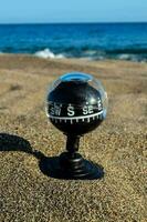 a compass on the beach photo