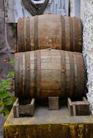 two wooden barrels sitting on top of a wooden block photo