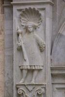 a stone sculpture of a man holding a staff photo