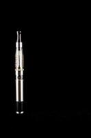 a silver electronic cigarette sitting on a black surface photo