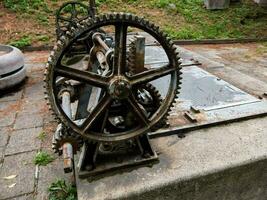 an old machine with gears on top of it photo