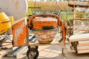 an old cement mixer sitting on a cart photo