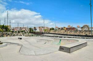 a skate park with a concrete ramp photo