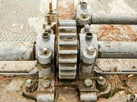 a close up of metal pipes with a gear photo