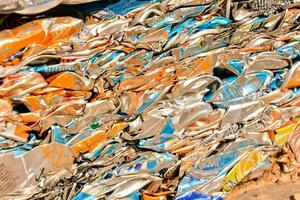 a pile of flattened cans on the ground photo