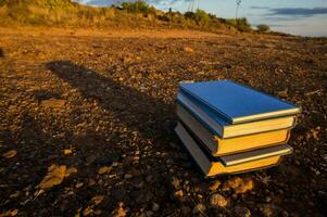 stack of books on the ground photo