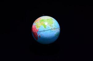 a globe on a black background with a black background photo