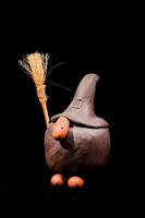 a ceramic witch with broom and hat photo