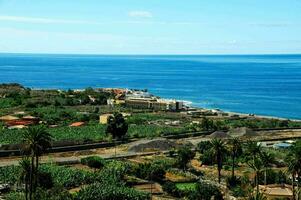 a view of the ocean and a small town on the coast photo