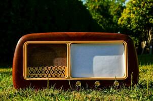 an old fashioned radio set in the grass photo