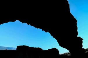 Silhouette of a rock formation photo