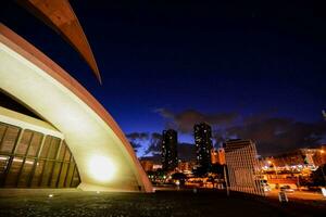 the opera house at night with the city in the background photo