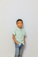 Cute little boy in casual outfit on background photo