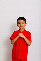 pequeño chico Moda sonriente niño en rojo chino vestido, estilo y Moda ideas para niños. chino nuevo año foto