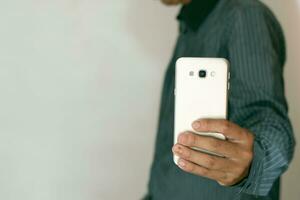 Close-up shot of man's hand using mobile phone, smartphone, working and talking. business idea photo