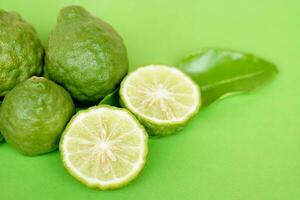 Bergamot fruits and leaves on  green  background. Concept, herbal fruits with sour taste, can be cooked as food seasoning and use for spa , aroma. Medicinal herb. photo