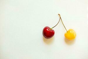 red and yellow cherries.berry pair of cherries. different but together. photo