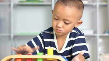 Boy playing with developmental toys on table at home video