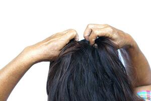 Woman use hands to scratch her itcy hair on head, isolated on white background. Concept, Hair health problems. Dandruff, fungus on scalp, allergic to shampoo or louse. photo