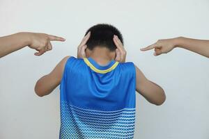Boy close his ears. Two fingers point to him. Concept, Depression, anxiety disorder angry, disobey, don't want to hear. Be bullied. Campaign for stop bullying that affect to mental health and behavior photo