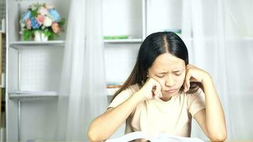 Woman reading at home desk video