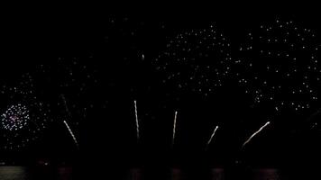 Amazing beautiful colorful firework display over sea on celebration night. Fireworks show for happy new year, 4k footage. video