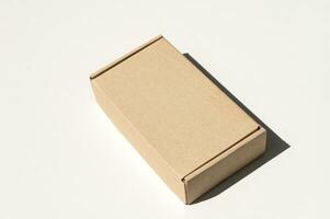 Rectangular closed box made of corrugated cardboard on a white background photo