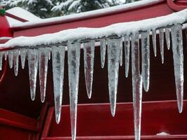 Icicles On A Red Sler. AI Generated photo