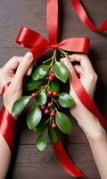 Photo Of Christmas Red Ribbon Tying A Bunch Of Mistletoe. AI Generated