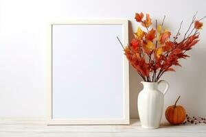 A mock-up of a white empty frame stands on a table with a vase and an autumn bouquet. AI Generated photo