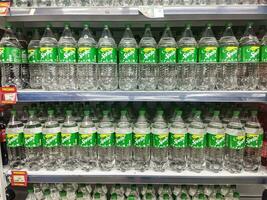 Surakarta, Indonesia - April 27, 2023. Sprite brand soft drink on display at a supermarket shelf in Surakarta. Sprite is a famous soft drink under the Coca-Cola brand. photo