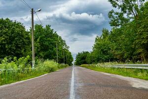 Beautiful empty asphalt road in countryside on colored background photo