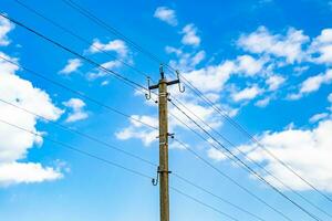 Power electric pole with line wire on colored background close up photo