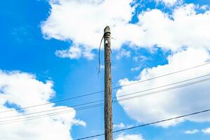 Power electric pole with line wire on colored background close up photo