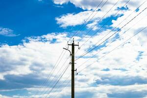 Power electric pole with line wire on colored background close up photo