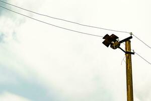 Power electric pole with line wire on colored background close up photo