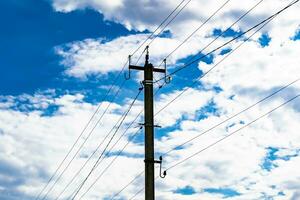 Power electric pole with line wire on colored background close up photo