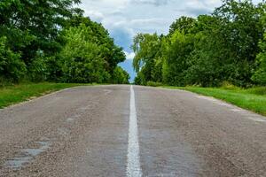 Beautiful empty asphalt road in countryside on colored background photo