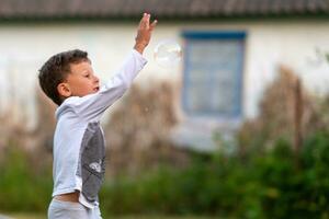 Beautiful baby boy with child soap bubbles posing photographer for cool photo