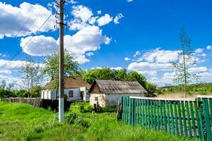 Beautiful old abandoned building farm house in countryside on natural background photo