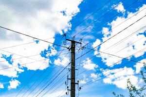 Power electric pole with line wire on colored background close up photo