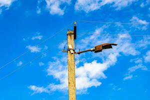 Power electric pole with line wire on colored background close up photo