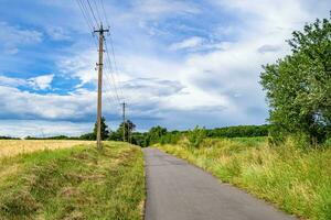 Beautiful empty asphalt road in countryside on colored background photo