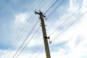 Power electric pole with line wire on colored background close up photo