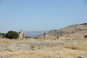 ANTALYA, TURKEY - MAY 15, 2021 Ruins of ancient city Hierapolis near Pamukkale, Turkey at sunny day. Parts of old historical buildings with big blocks photo