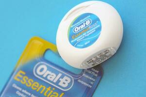 KYIV, UKRAINE - JULY 7, 2023 Oral-B Essentail Floss. Waxed dental floss in round case photo