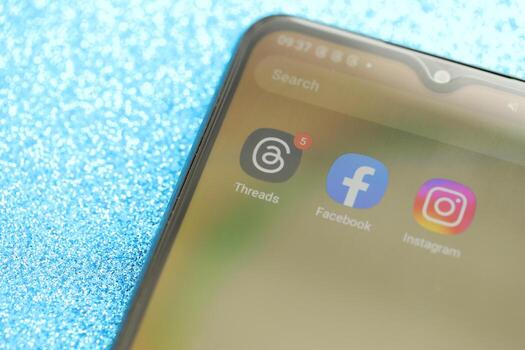 KYIV, UKRAINE - JULY 7, 2023 Threads by Meta application on display of Samsung smartphone lying on table photo